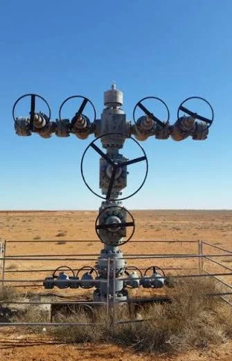 Wellhead on an outback site under a clear sky